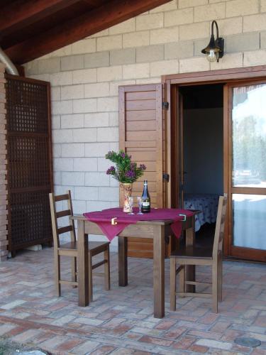 a table and chairs with a purple table cloth on a patio at Podere 1248 in Ladispoli