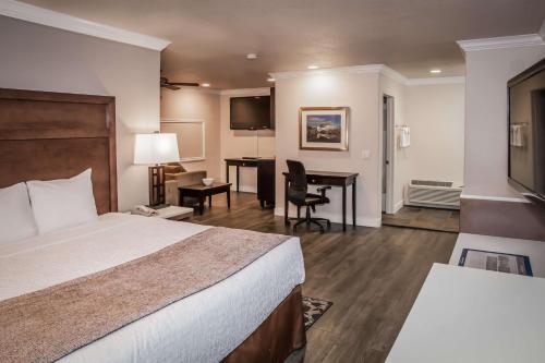 a hotel room with a bed and a desk at Best Western Bishop Lodge in Bishop