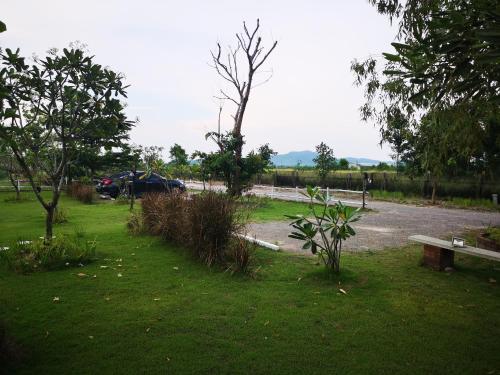 a park with a car parked in a parking lot at Terrua Main Ten Villa Garden in Suan Phung