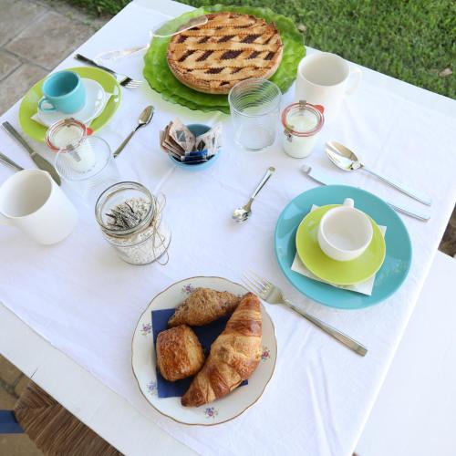 a white table with plates of food on it at Podere 43 Charme B&B in Otranto
