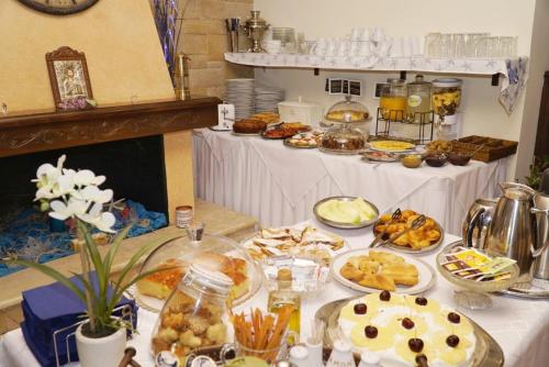 a table with many plates of food on it at ''EPAVLIS boutique GALAXIDI'' in Galaxidhion