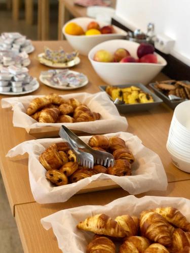 a table with various types of pastries and other foods at Hotel Class in Brezoi