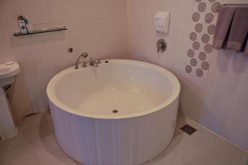 a white bath tub in a bathroom with a toilet at Hotel Diamant in Seoul