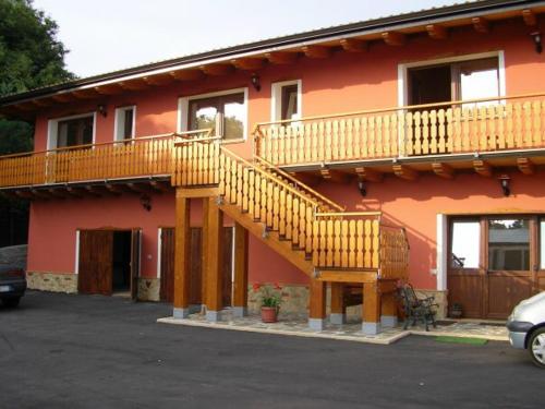 a red building with a staircase on the side of it at B&B COLLE DI CONDRO in Serrastretta