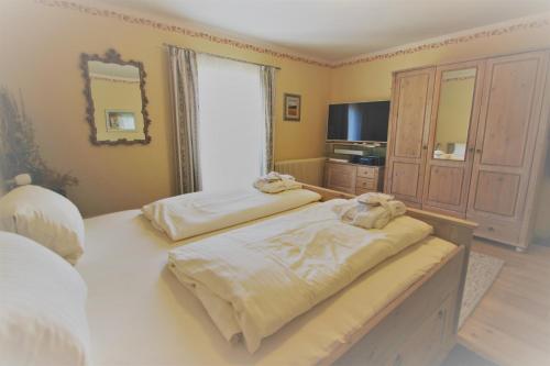 a bedroom with two beds with towels on them at Alpenlandhaus Menardi in Seefeld in Tirol