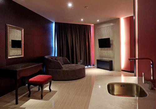 a living room with a couch a chair and a table at TSix5 Quarter in Pattaya North