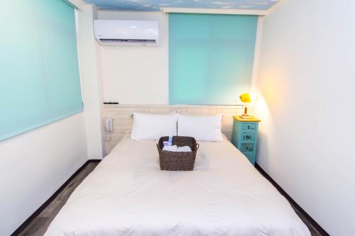 Cama o camas de una habitación en Meizhou Hot Spring Hotel溫泉商旅