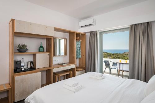 a hotel room with a bed and a view of the ocean at Glykeria Hotel in Elafonisi