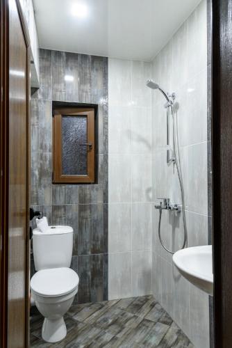 a bathroom with a toilet and a sink at Gradina in Chernomorets