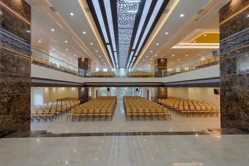 a large auditorium with rows of chairs in a building at Hotel Lance International in Nāgercoil