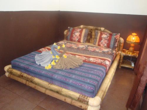 a bedroom with a bed with a doll on it at Relaxing Homestay in Kuta Lombok