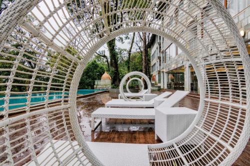 a circular building with a table and chairs at Elixir Hills Suites Resort and Spa in Munnar