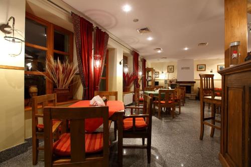 a dining room with wooden tables and chairs at Hotel Fero Lux in Korbielów