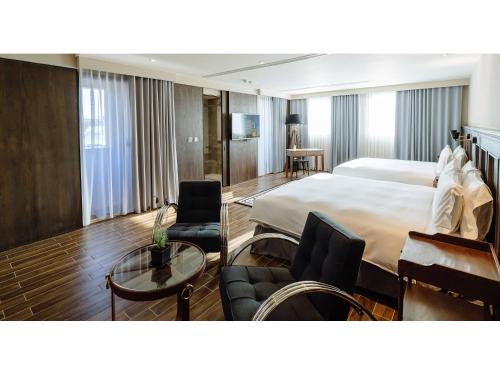 Katil atau katil-katil dalam bilik di Hôtel de Ľeau