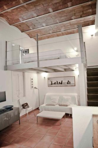 a living room with a white couch and a chandelier at Barceloneta Suites Apartments Beach in Barcelona