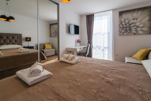 a bedroom with two beds and a large mirror at SOBE "GALEB" in Vrbnik