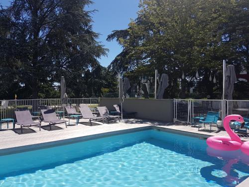 a swimming pool with a pink flamingo in the water at Novotel Toulouse Purpan Aéroport in Toulouse