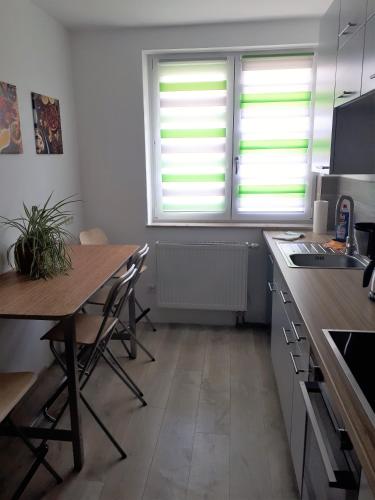 a kitchen with a table and two windows and a desk at Wohnung in Datteln in Datteln