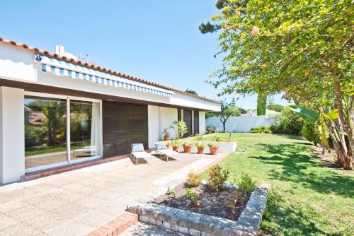 a patio with two benches in a yard at BmyGuest - Sesimbra Country Villa in Sesimbra