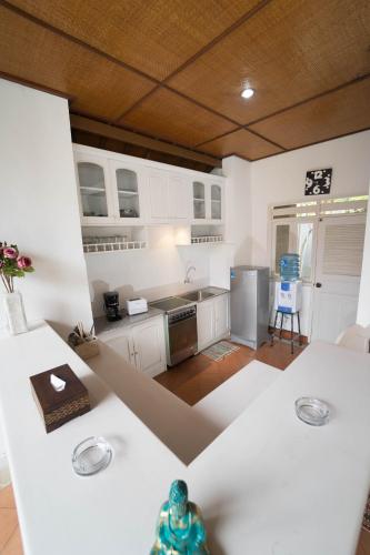 a kitchen with white cabinets and a counter top at Mudha Bali Villa Sanur 4 Bedrooms in Sanur