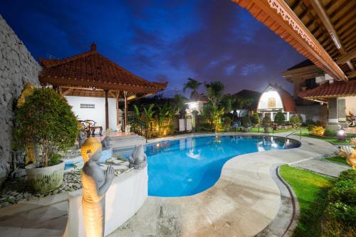 a swimming pool in a resort at night at Mudha Bali Villa Sanur 4 Bedrooms in Sanur