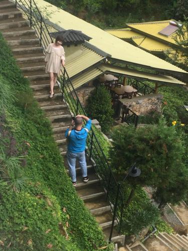 two people walking up the stairs of a house at Train View Chalet in Bandarawela