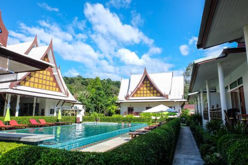 a view of the courtyard of a resort with a swimming pool at Bhu Tarn Koh Chang Resort & Spa in Ko Chang