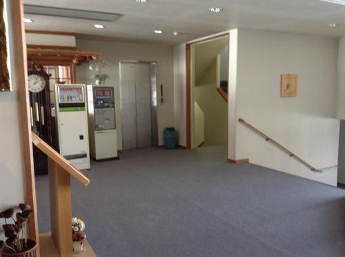 an empty hallway in a building with a refrigerator at Happokan in Hakuba