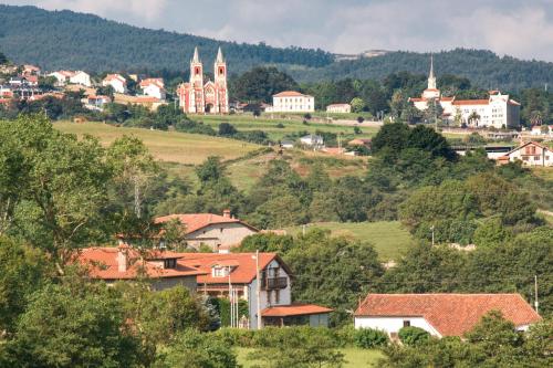 a small town on a hill with buildings and trees at Apartamentos Costa Esmeralda in Suances