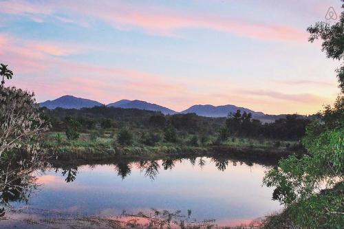 a view of a river with mountains in the background at Thai Muang Resort in Thai Muang