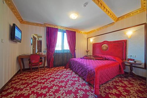 a hotel room with two beds and a television at Antea Palace Hotel & Spa in Istanbul