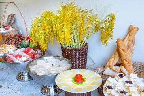 a table topped with plates and bowls of food at Sapa Relax Hotel & Spa in Sa Pa