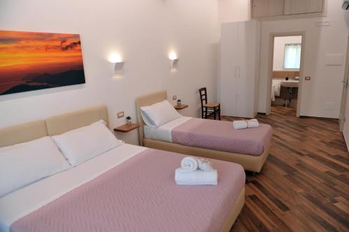 a hotel room with two beds with towels on them at Il covo degli Dei in Agerola