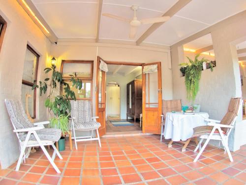 a room with a table and chairs on a tile floor at Elly's Place B&B in Darling