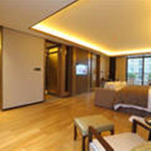 a living room with a couch and a table at S&N Zhejiang LinHai International Hotel in Linhai