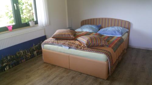 a bedroom with a bed with pillows on it at "Morgensonne" in Halsdorf