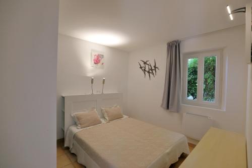 a bedroom with a bed and a window at Au bastidon de Gordes in Gordes
