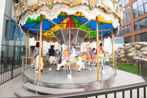 a carousel with people riding horses on it at Vila Gale Collection Sintra in Sintra