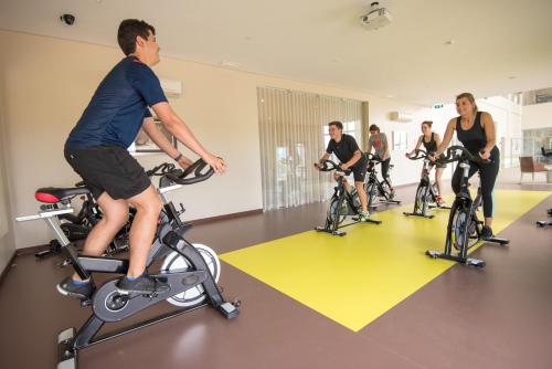 a group of people riding bikes in a gym at Vila Gale Collection Sintra in Sintra