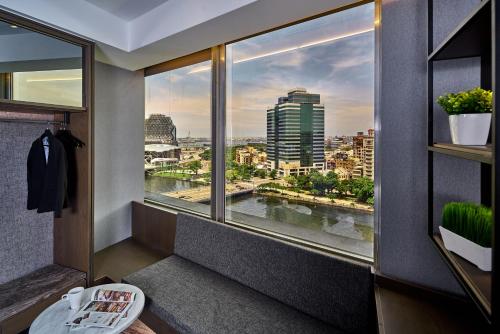 a room with a window with a view of a city at Harbour 10 Hotel in Kaohsiung