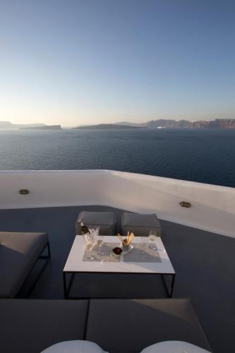 a table on a boat with a view of the ocean at Akrotiri Cove in Akrotiri