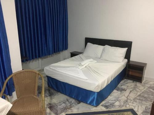 a bedroom with a bed and a chair in it at Bodrum Blu Hotel in Bodrum City