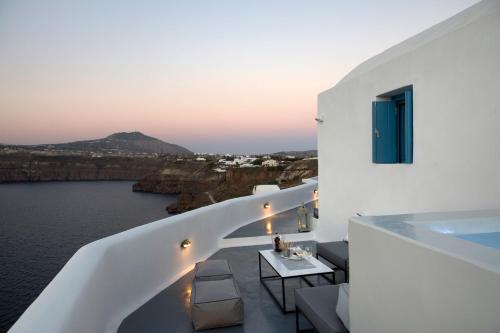 a white balcony with a view of the water at Akrotiri Cove in Akrotiri