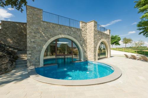 a swimming pool in the middle of a house at Borgo La Chiaracia Resort & SPA in Castel Giorgio