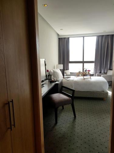 a hotel room with a bed and a desk with a chair at ODYSSEE Boutique Hotel Casablanca in Casablanca