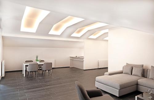 a living room with a couch and a table at Le Pave Hotel in Bayt al Kūkū
