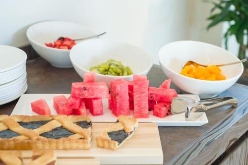 a plate of watermelon and pretzels and fruit on a table at Borgo La Chiaracia Resort & SPA in Castel Giorgio