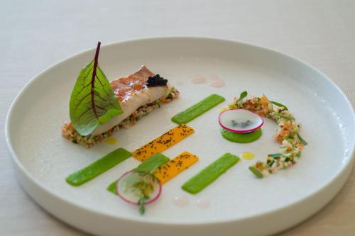a white plate with some food on it at Borgo La Chiaracia Resort & SPA in Castel Giorgio