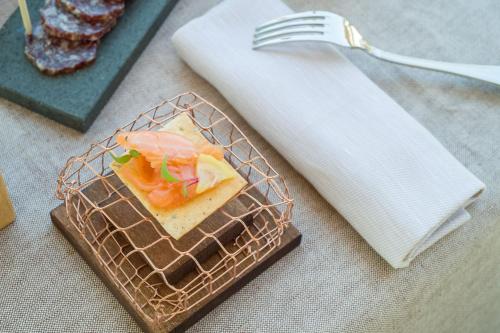 a plate of food on a table with a fork at Borgo La Chiaracia Resort & SPA in Castel Giorgio