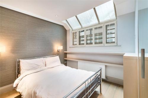 1 dormitorio con cama y ventana en Luxury Apartments in Westminster, en Londres